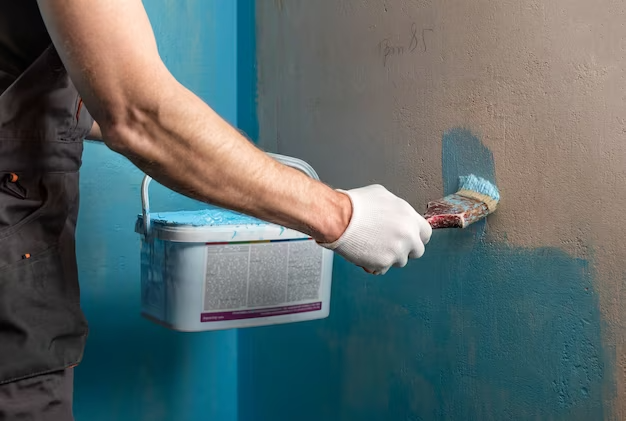 worker-applying-waterproofing-paint-wall